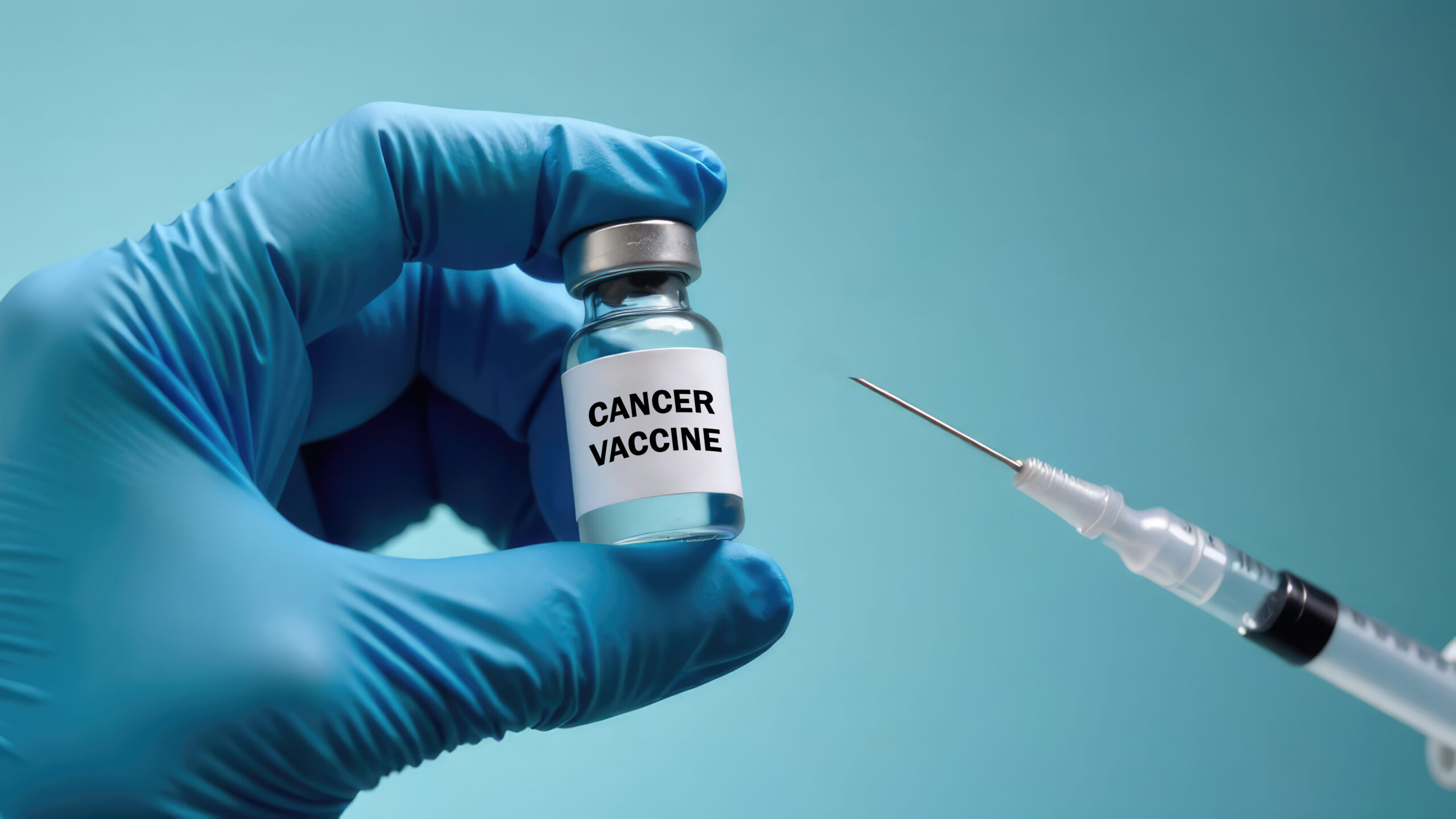 A gloved hand holds a vial of cancer vaccine next to a syringe on a blue background. Concept of cancer vaccine research and treatment.