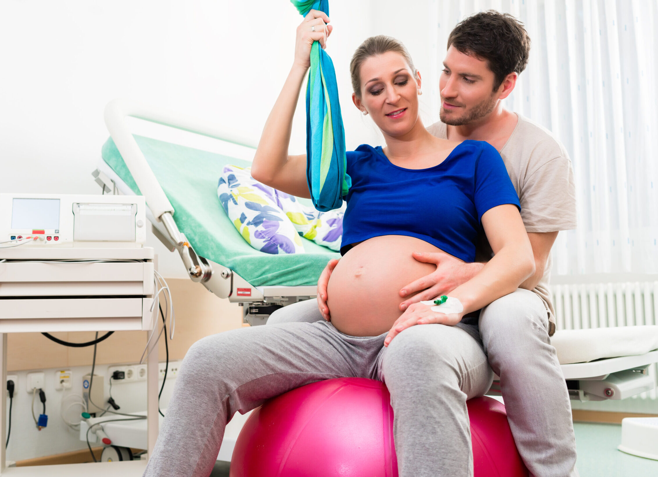 Pregnant woman and man in delivery room of hospital
