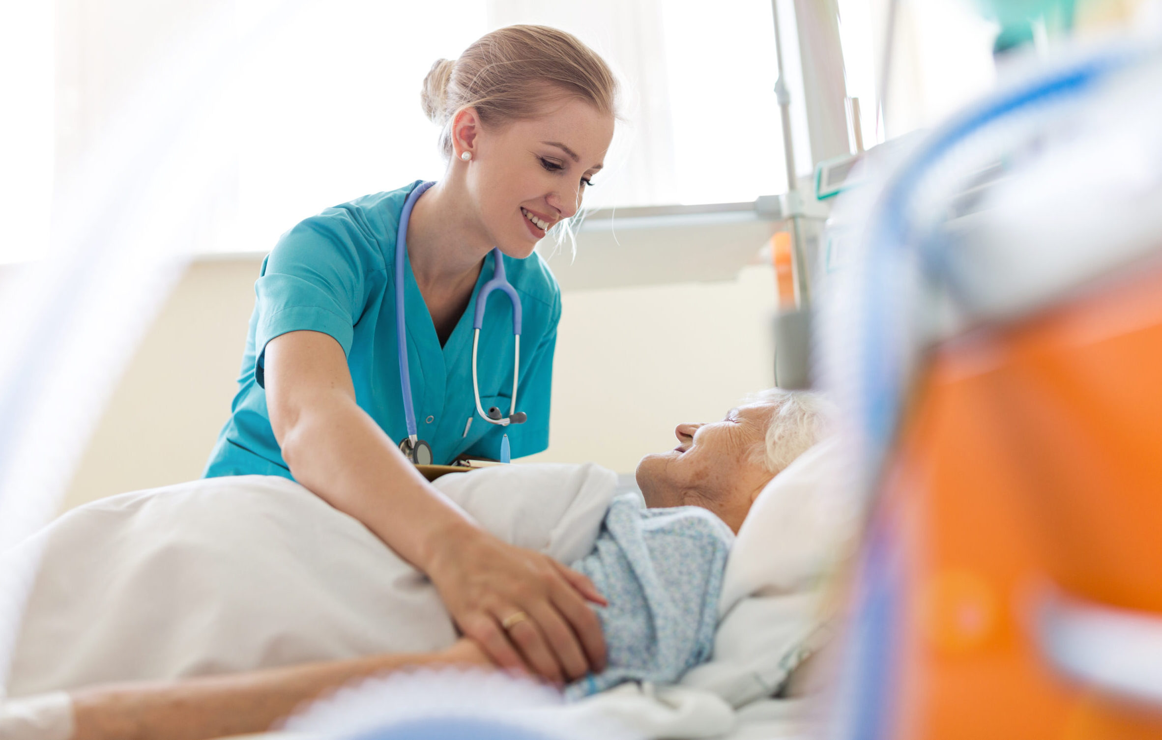 Senior patient and nurse in hospital