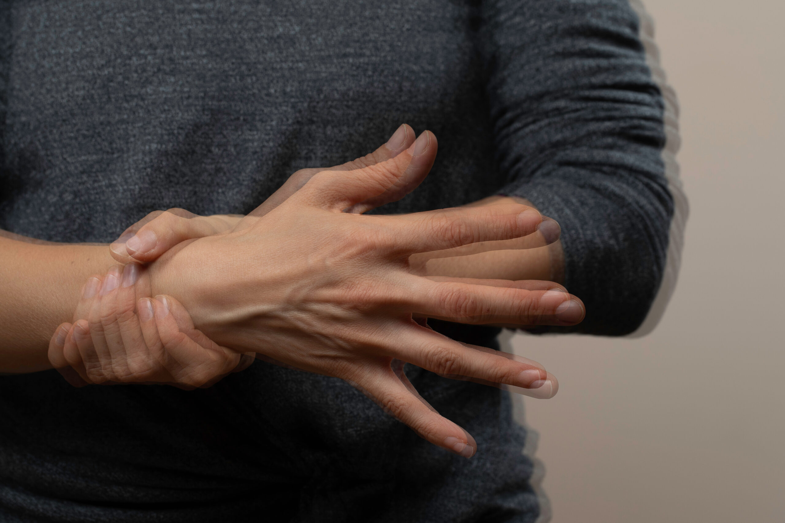 Woman with trembling hands, nervous gesture
