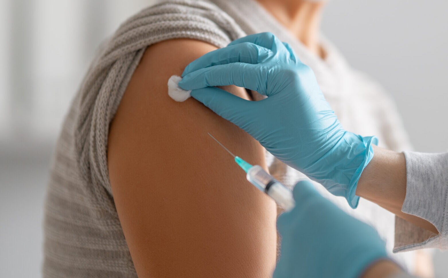 Doctor giving a senior woman vaccination