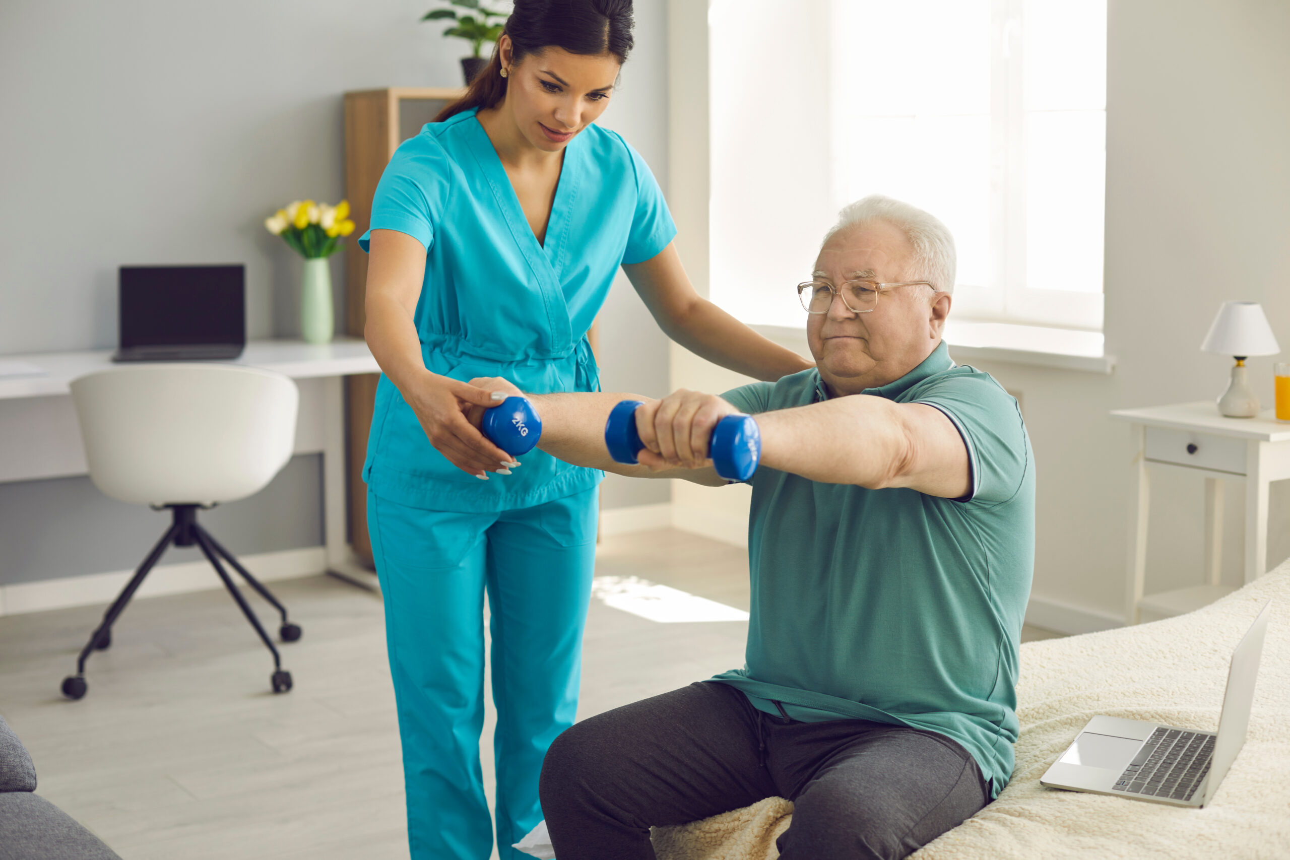 Physiotherapist or home care nurse helping senior patient do rehabilitation exercise