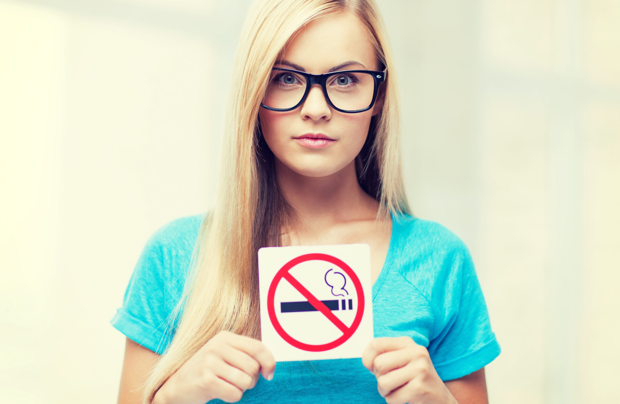 woman with smoking restriction sign