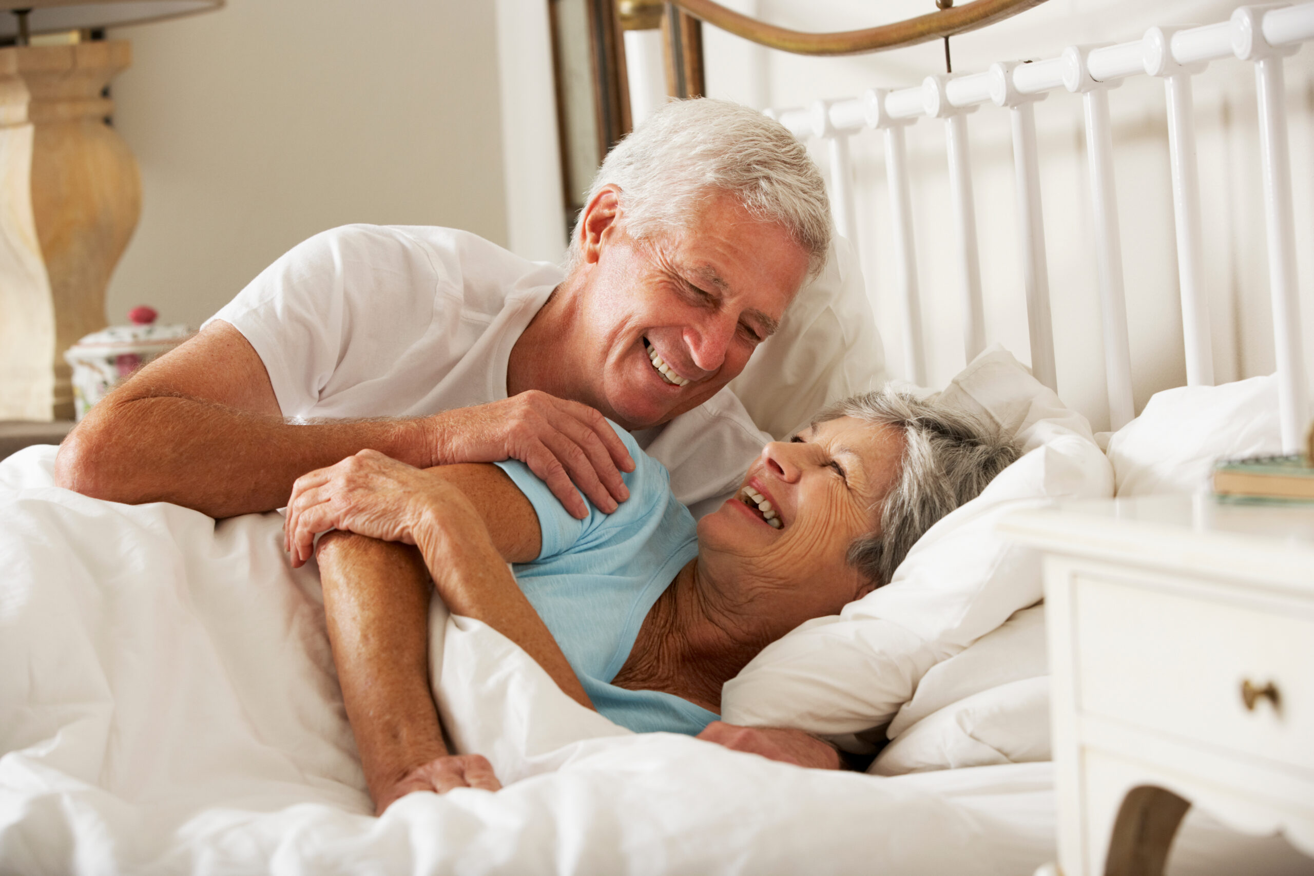 Happy Senior Couple In Bed Together